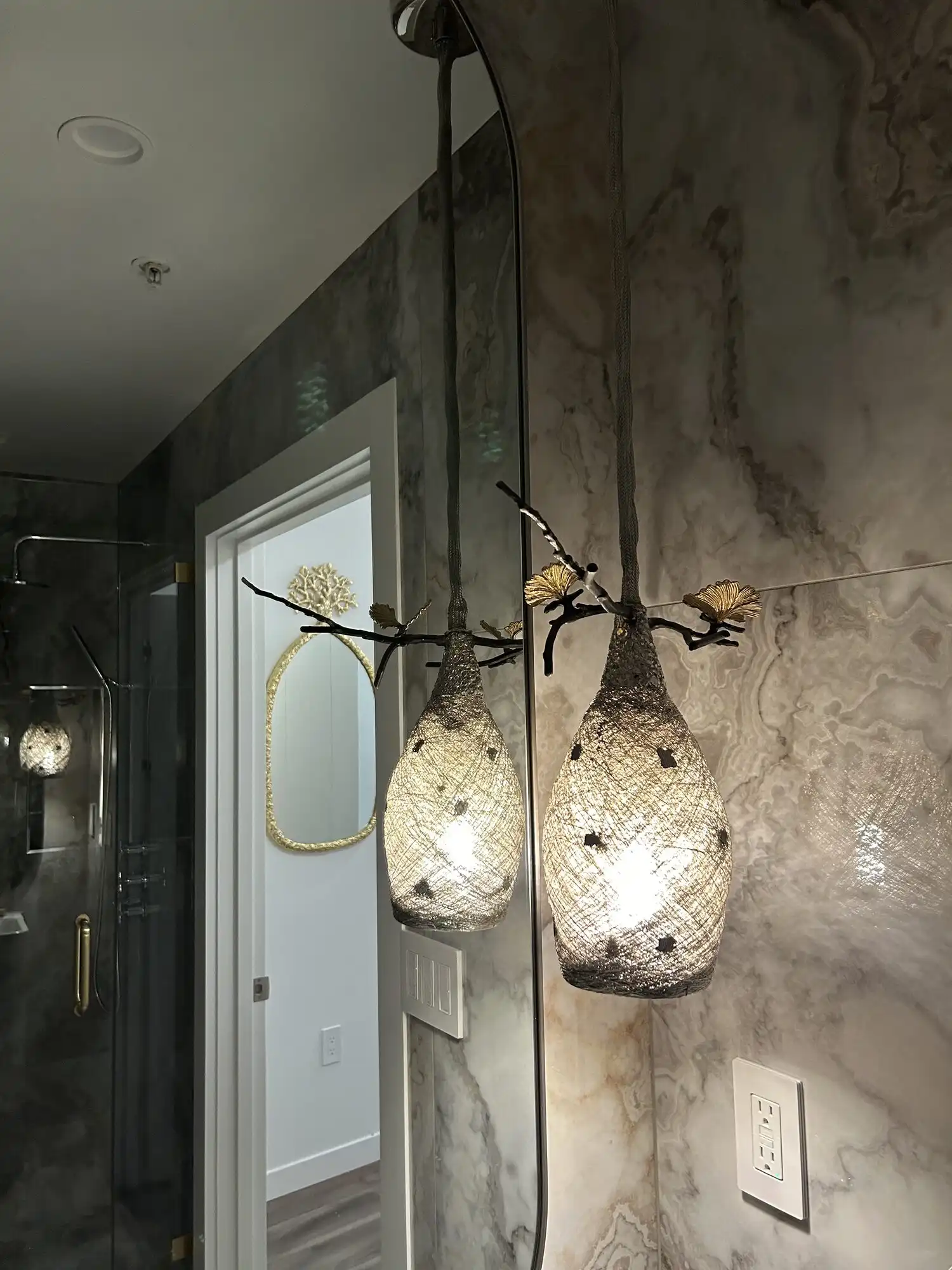 Designer pendant and recessed lighting in a marble-tiled luxury bathroom, Bellevue high-rise