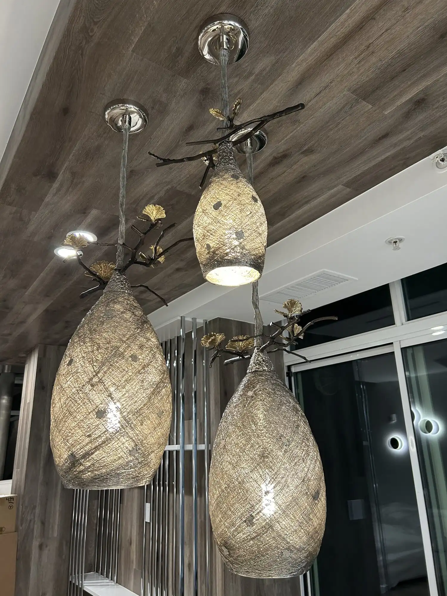 Three designer metal-mesh pendant lights with gold leaf accents installed in a Bellevue condo