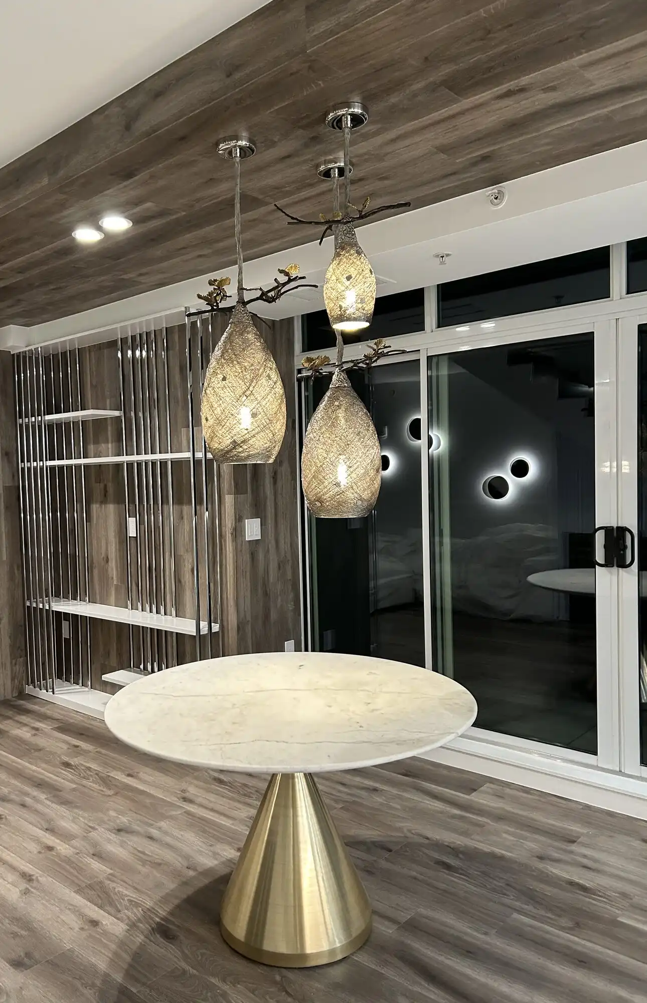 Designer pendant cluster and recessed lights over a dining table in a Bellevue high-rise condo