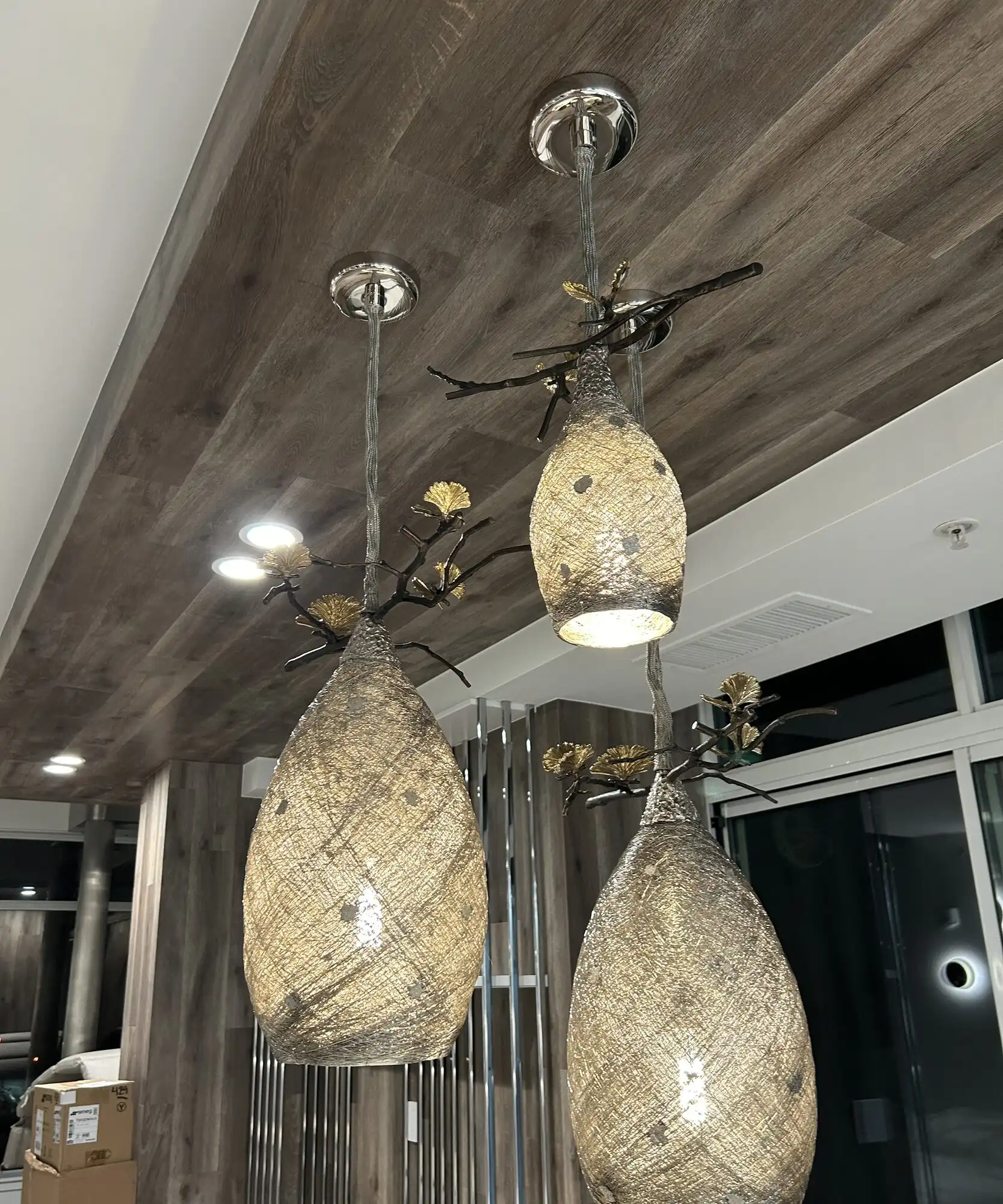 Custom pendant lights and recessed downlights installed in a wood-plank ceiling, Bellevue high-rise