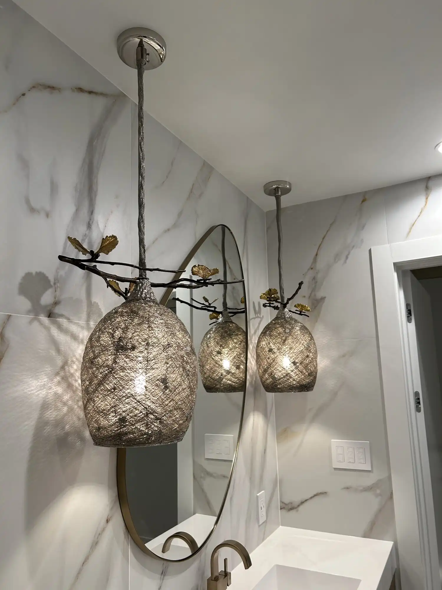 Two designer mesh pendants with gold leaf detail installed in a Bellevue condo bathroom by a Seattle-area electrician