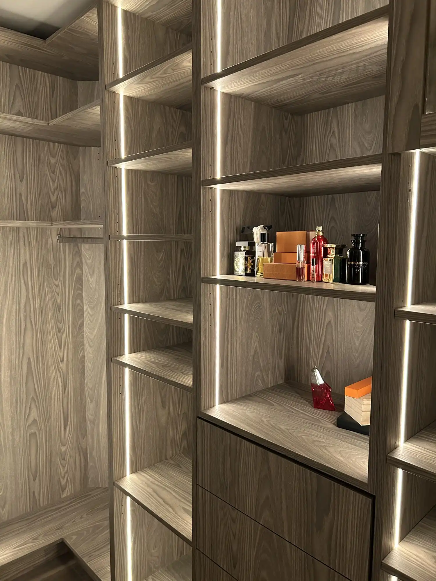 Vertical LED strip lighting integrated into closet shelving, Bellevue luxury condo electrical work