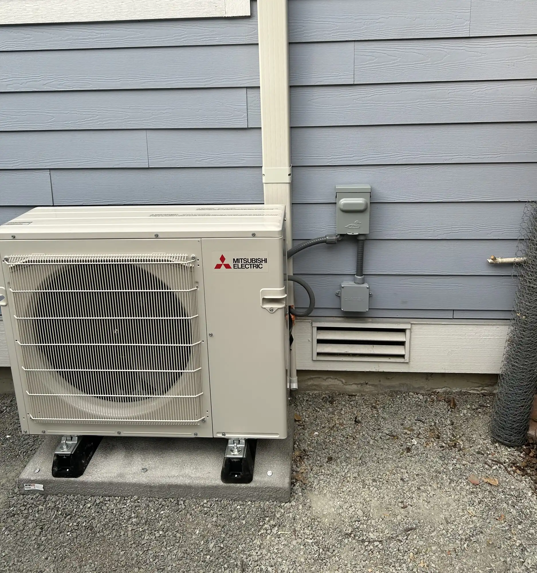 Mitsubishi Electric heat pump outdoor unit with new disconnect wired by electrician in Seattle Columbia City