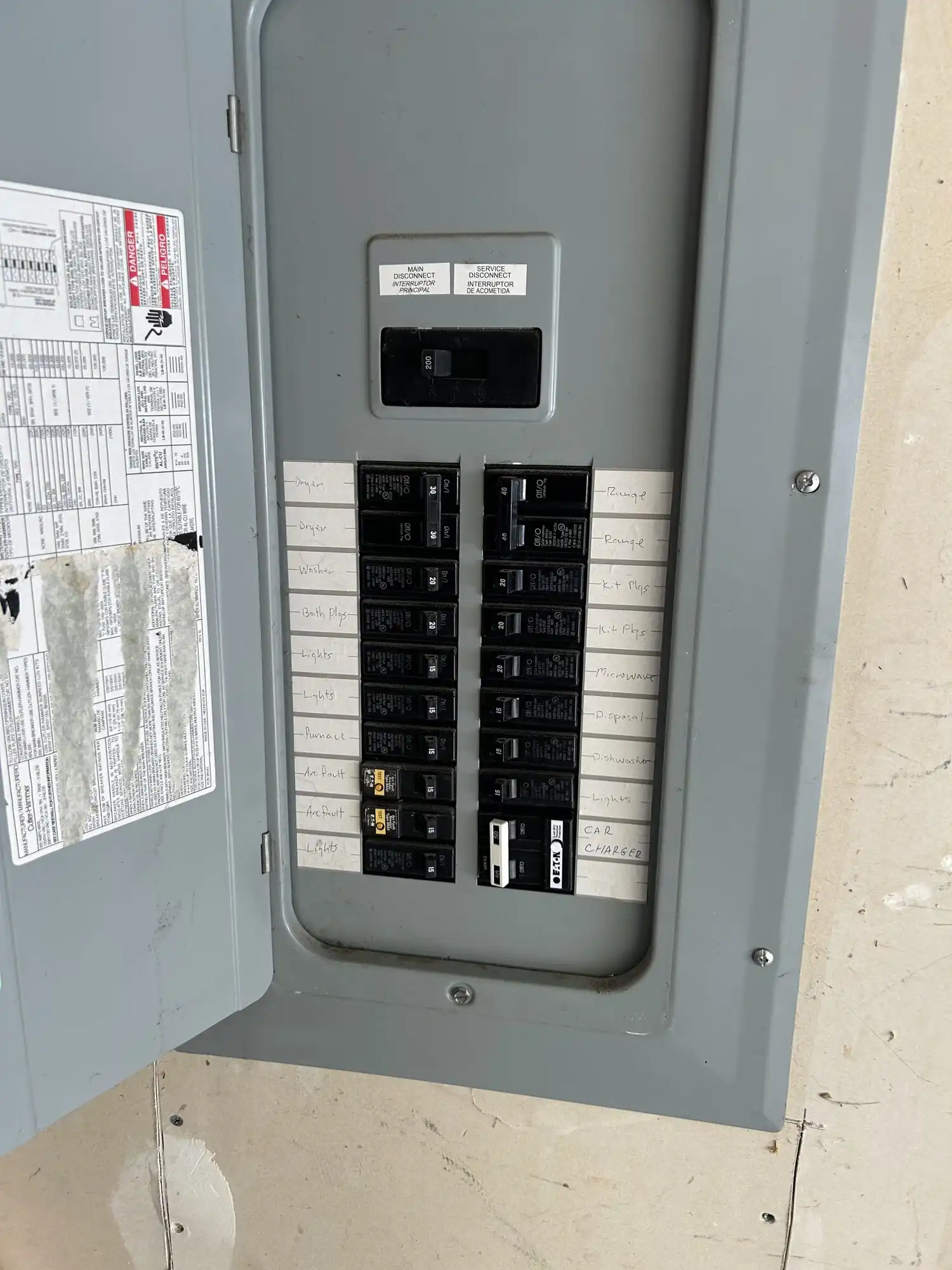 200A residential electrical panel in Everett WA garage with new Eaton breaker labeled Car Charger for EV charger circuit