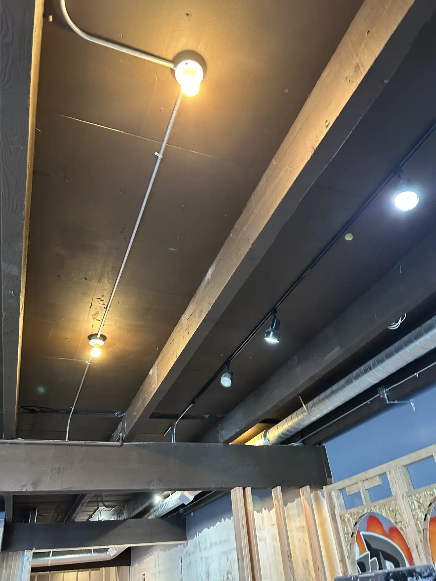 EMT conduit and track lighting rough-in on an exposed ceiling, Federal Way restaurant tenant improvement