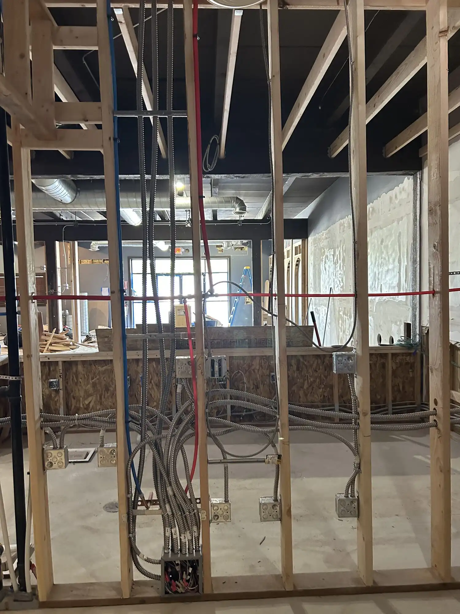 Dense MC cable and conduit rough-in through framing, Federal Way restaurant and bar build-out