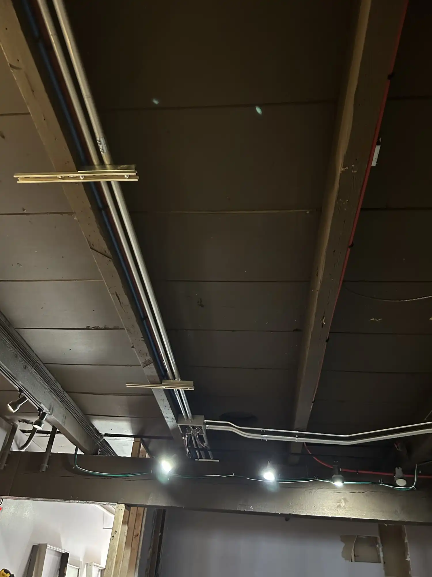 Surface EMT conduit run to ceiling lighting outlets, Federal Way restaurant tenant improvement