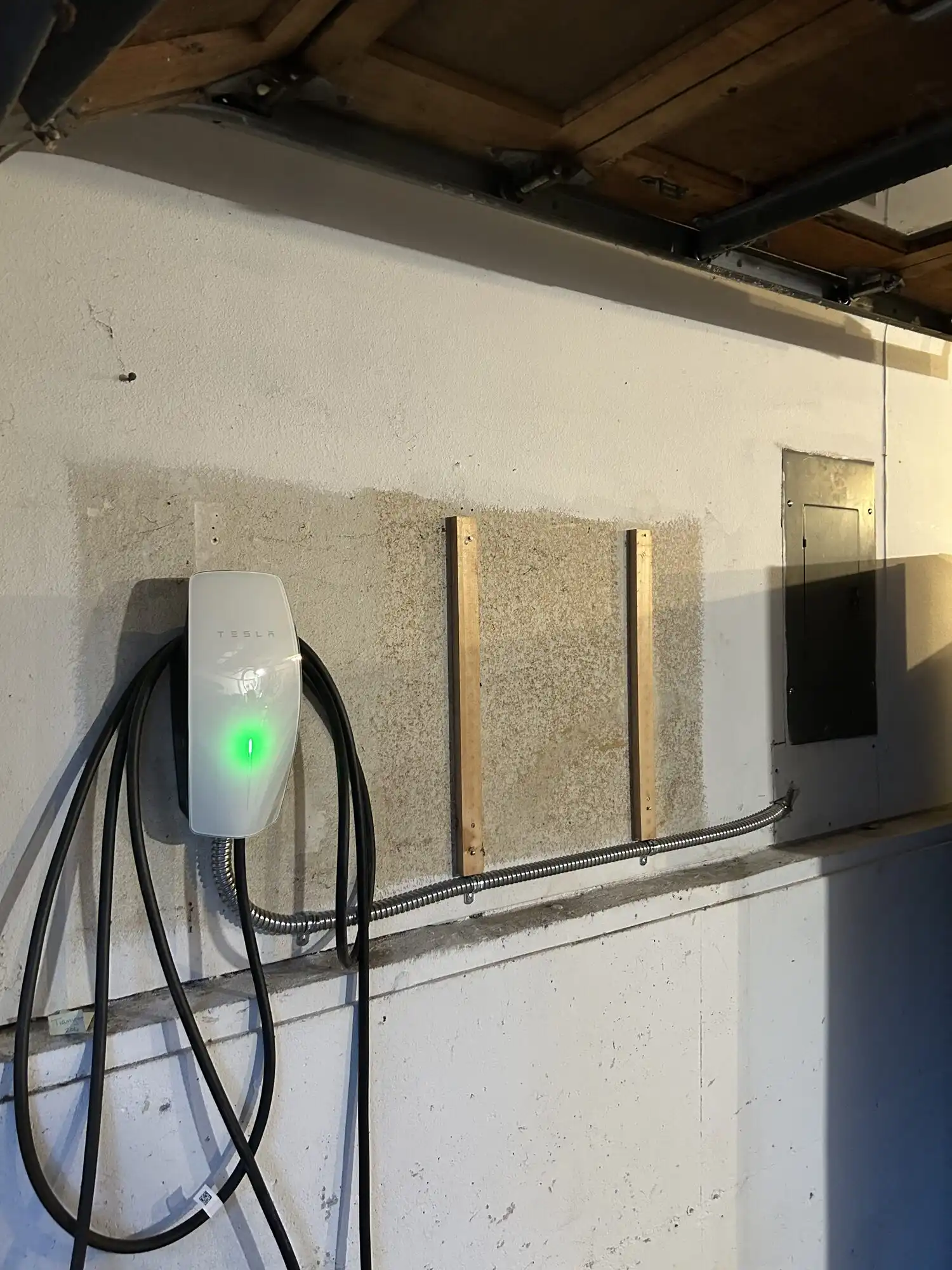 Tesla Wall Connector installation in Federal Way WA garage showing conduit run to panel