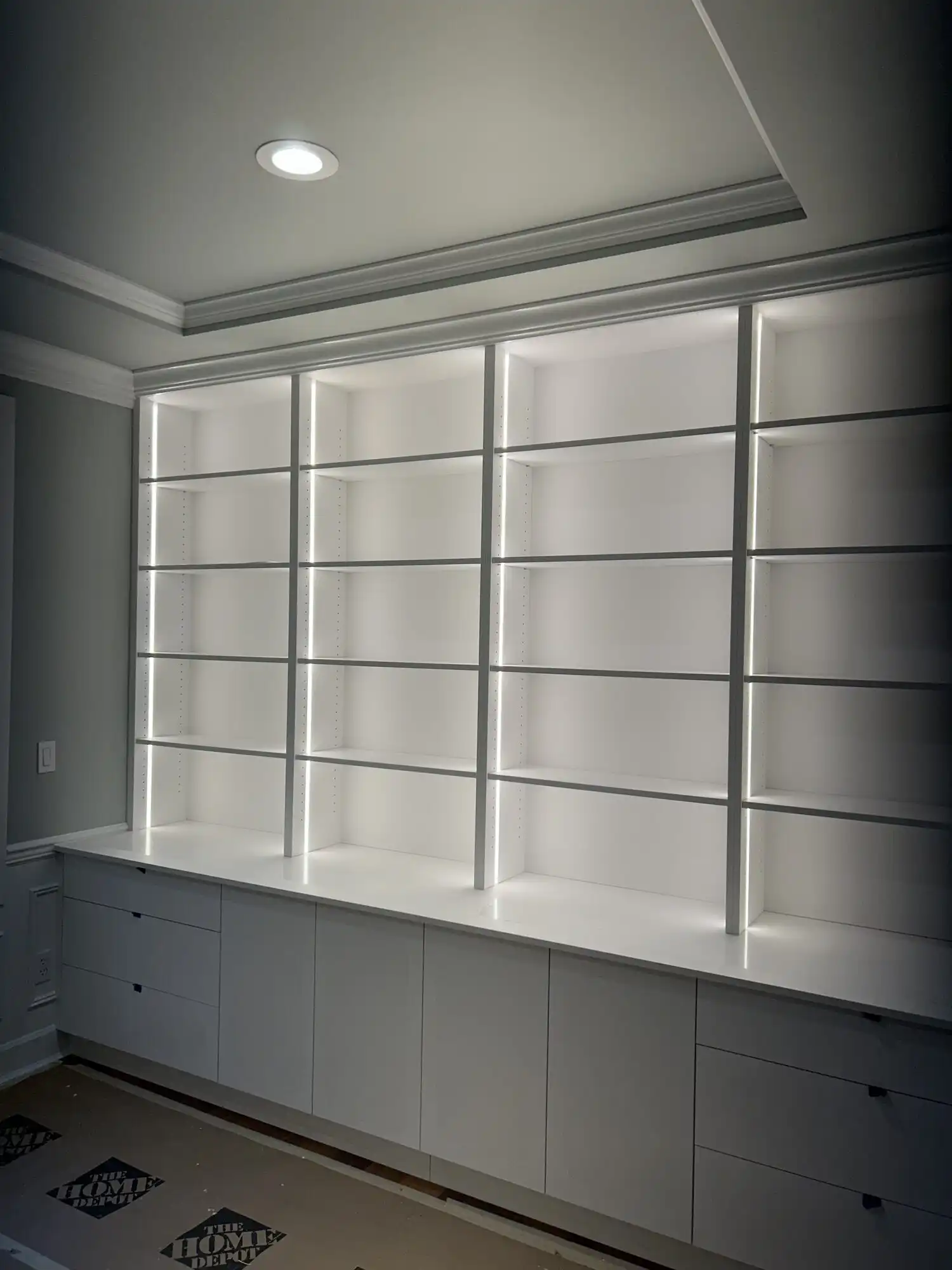 Custom built-in bookshelves with integrated LED strip lighting installed in Sammamish WA home