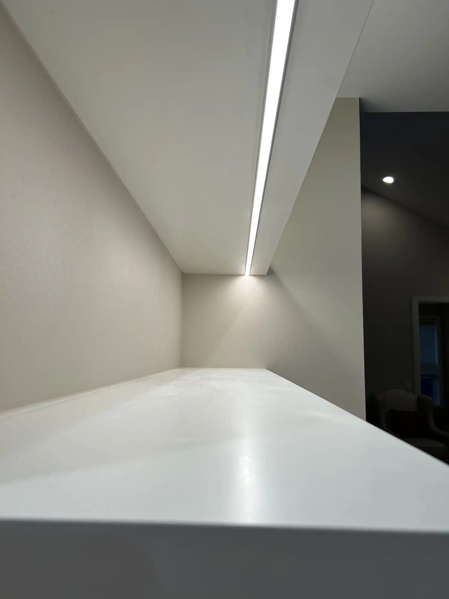 Recessed LED channel lighting under a custom floating shelf, millwork lighting install in Sammamish, WA